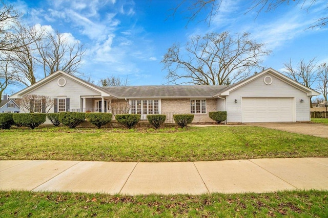 single story home featuring brick siding, a garage, driveway, and a front yard