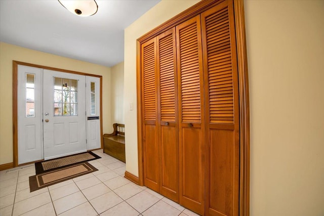 entrance foyer with light tile patterned flooring and baseboards
