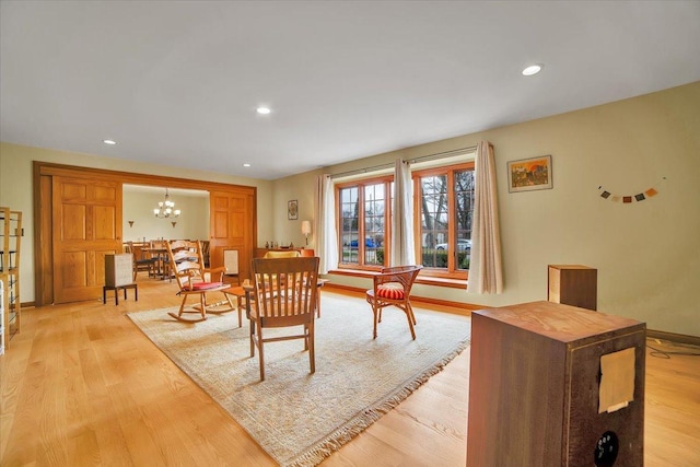 interior space featuring recessed lighting, light wood finished floors, baseboards, and a chandelier