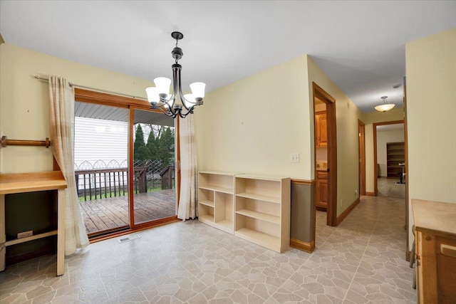 unfurnished dining area featuring stone floors, a notable chandelier, and visible vents