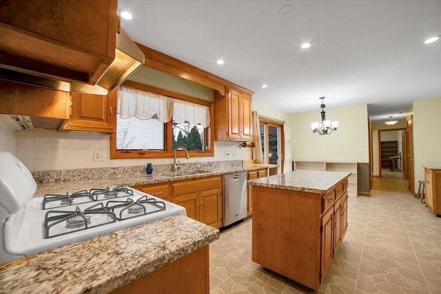 kitchen with a center island, dishwasher, a sink, gas stove, and a chandelier