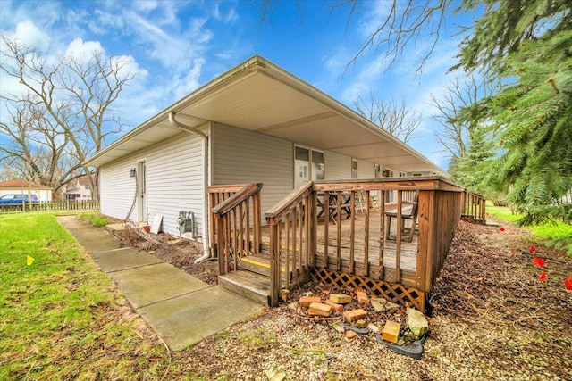 exterior space with fence and a wooden deck