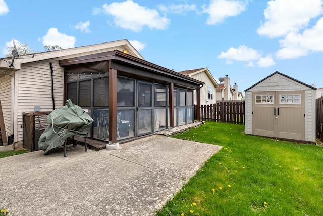 14004 Whipple St, Blue Island, IL 60406 - back of property featuring fence, a storage shed, a sunroom, an outbuilding, and a yard