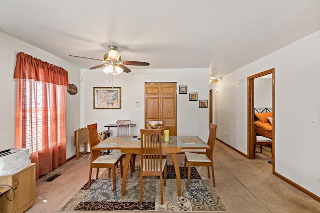 14004 Whipple St, Blue Island, IL 60406 - dining room featuring visible vents, baseboards, ceiling fan, and light carpet