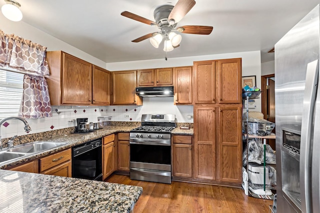 14004 Whipple St, Blue Island, IL 60406 - kitchen featuring a sink, under cabinet range hood, brown cabinets, a ceiling fan, and appliances with stainless steel finishes