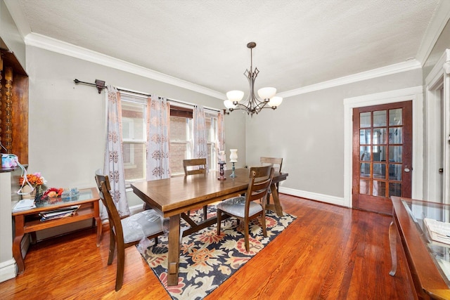 1314 S 59th Ct, Cicero, IL 60804 - dining space with an inviting chandelier, wood finished floors, baseboards, and ornamental molding