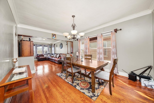 1314 S 59th Ct, Cicero, IL 60804 - dining room with baseboards, ornamental molding, a chandelier, and wood finished floors