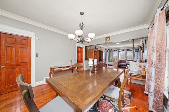 1314 S 59th Ct, Cicero, IL 60804 - dining room featuring a chandelier, ornamental molding, and wood finished floors