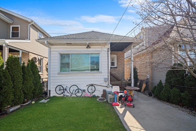 1314 S 59th Ct, Cicero, IL 60804 - rear view of house with a yard, roof with shingles, and fence