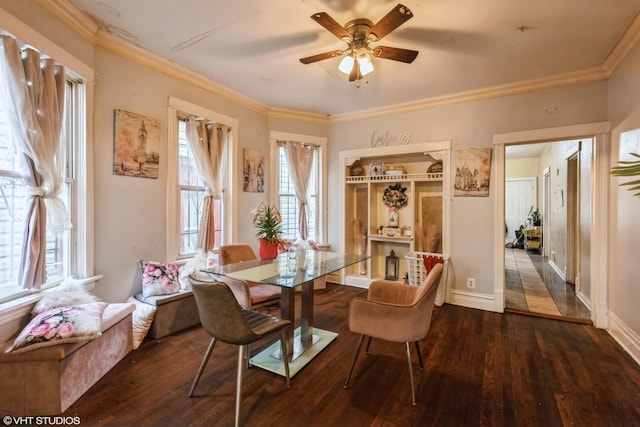 dining space with crown molding, baseboards, wood-type flooring, and a ceiling fan