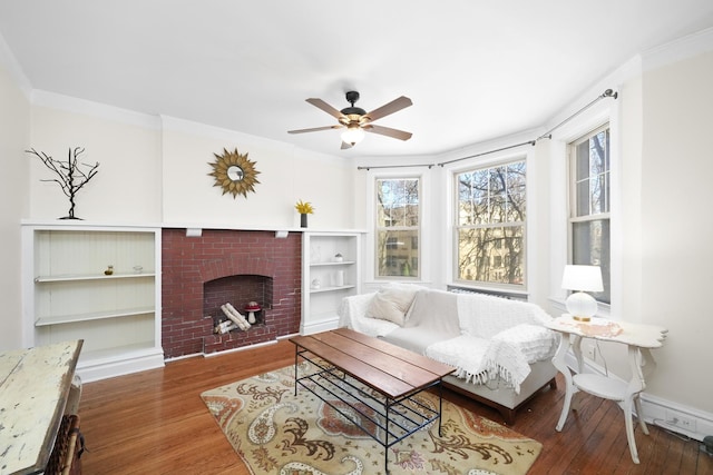 living room with ceiling fan, a wealth of natural light, and wood finished floors