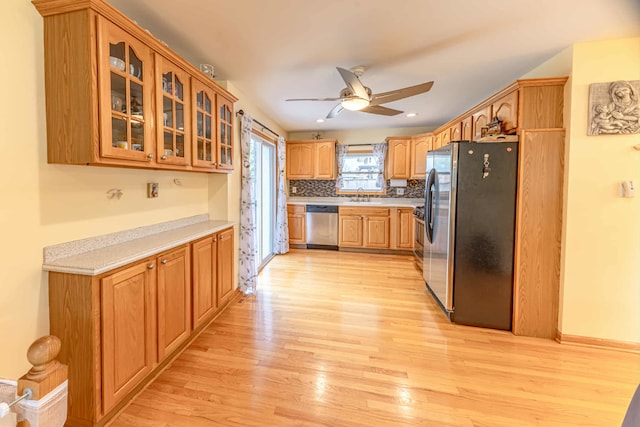 750 Evergreen Ln, Bartlett, IL 60103 - kitchen with appliances with stainless steel finishes, a sink, light wood finished floors, light countertops, and ceiling fan