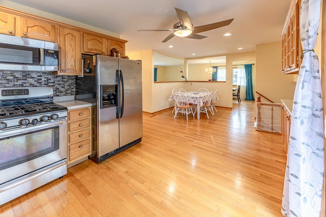 750 Evergreen Ln, Bartlett, IL 60103 - kitchen featuring appliances with stainless steel finishes, a ceiling fan, light countertops, tasteful backsplash, and light wood-style flooring