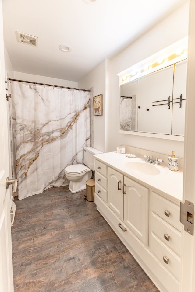 750 Evergreen Ln, Bartlett, IL 60103 - full bathroom with wood finished floors, toilet, and vanity