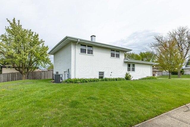 750 Evergreen Ln, Bartlett, IL 60103 - view of home's exterior with central AC unit and a chimney