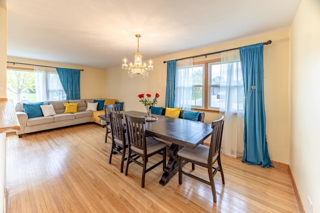 750 Evergreen Ln, Bartlett, IL 60103 - dining room featuring a chandelier, light wood-type flooring, and baseboards
