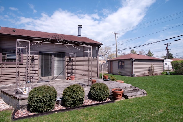 back of property featuring fence, a wooden deck, and a yard