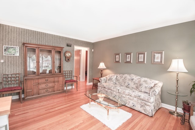 living area featuring baseboards, ornamental molding, wood finished floors, and wallpapered walls