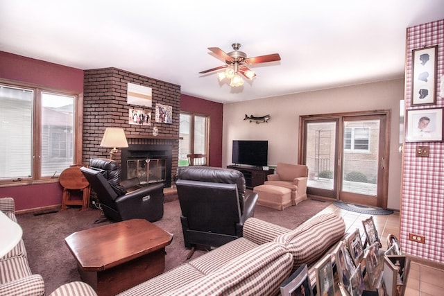 carpeted living room with baseboards, a ceiling fan, and a fireplace