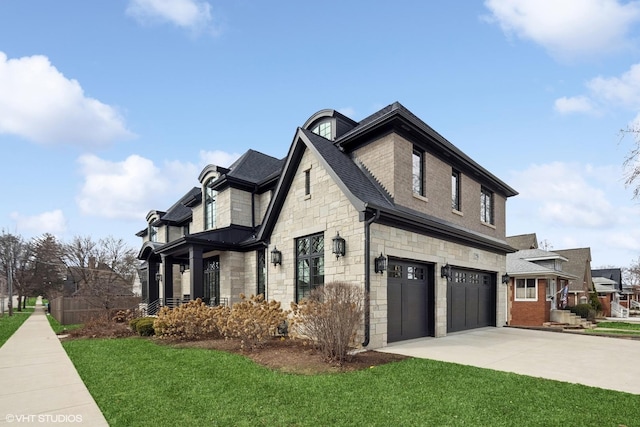 view of side of home featuring concrete driveway, a yard, an attached garage, and stone siding