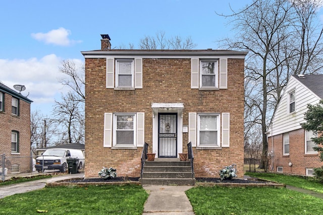 14113 Calumet Ave, Dolton, IL 60419 - view of front of house featuring a chimney, brick siding, entry steps, and a front lawn