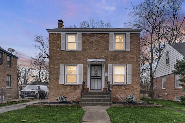 14113 Calumet Ave, Dolton, IL 60419 - view of front of house featuring a chimney, brick siding, and a yard