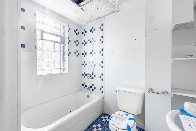 bathroom featuring toilet, bathing tub / shower combination, tile patterned floors, and a healthy amount of sunlight