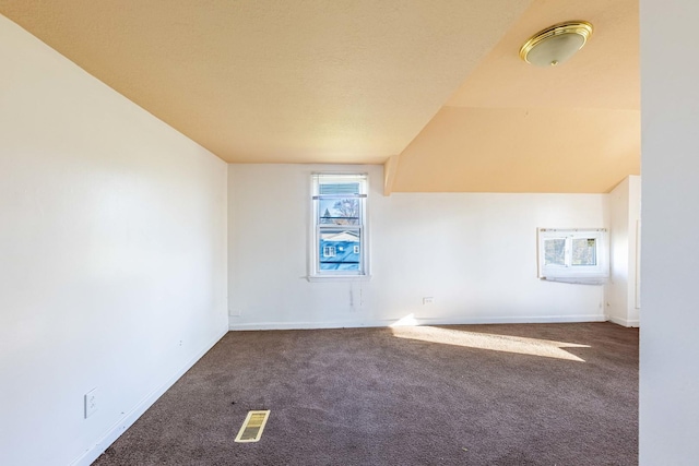 bonus room featuring baseboards, visible vents, and carpet