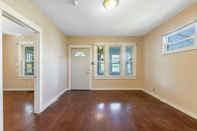 foyer featuring hardwood / wood-style floors and baseboards