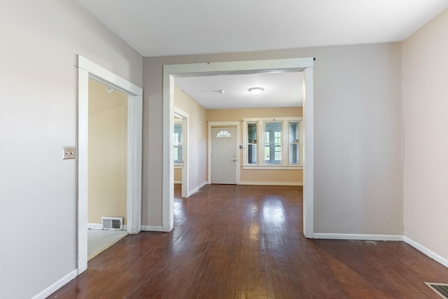 foyer with visible vents, hardwood / wood-style flooring, and baseboards