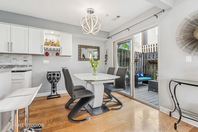 1352 N Knollwood Dr, Palatine, IL 60067 - dining area with light wood-type flooring, a chandelier, and baseboards