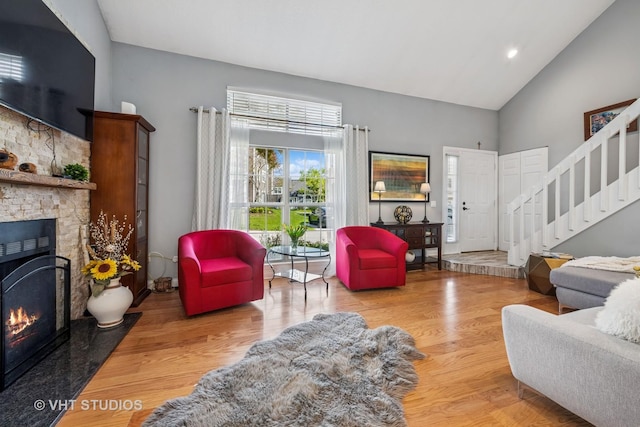 1352 N Knollwood Dr, Palatine, IL 60067 - living area featuring high vaulted ceiling, stairway, a fireplace, wood finished floors, and recessed lighting