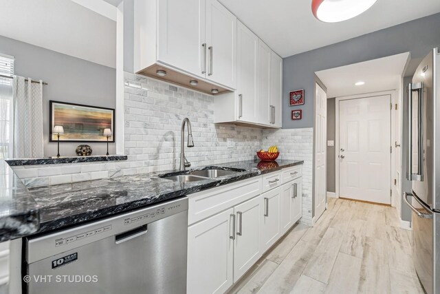 1352 N Knollwood Dr, Palatine, IL 60067 - kitchen featuring appliances with stainless steel finishes, a sink, white cabinets, dark stone counters, and tasteful backsplash