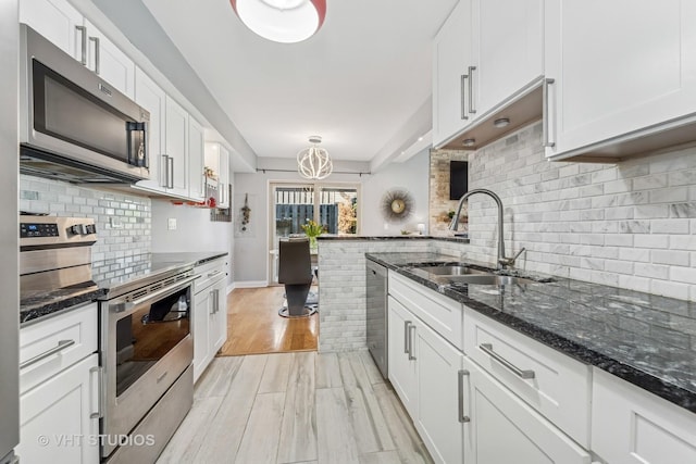 1352 N Knollwood Dr, Palatine, IL 60067 - kitchen with stainless steel appliances, a sink, backsplash, and white cabinets