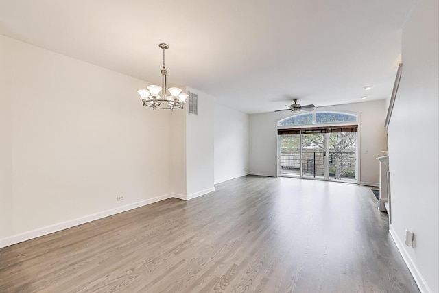 5350 N Damen Ave Unit F, Chicago, IL 60625 - unfurnished room featuring visible vents, baseboards, ceiling fan with notable chandelier, and wood finished floors