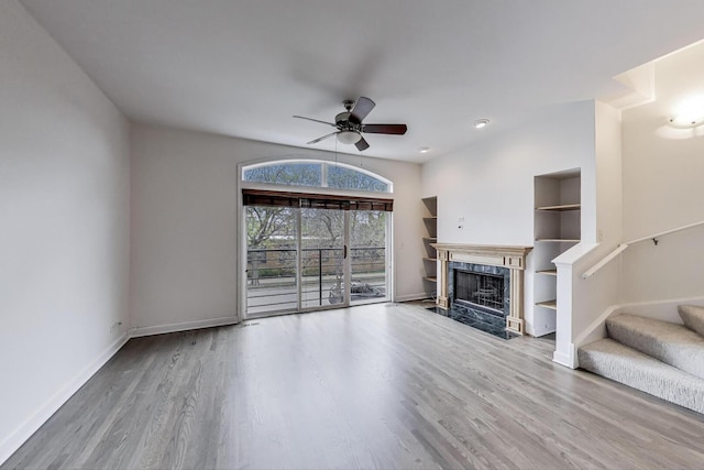 5350 N Damen Ave Unit F, Chicago, IL 60625 - living room featuring wood finished floors, baseboards, ceiling fan, stairway, and a high end fireplace