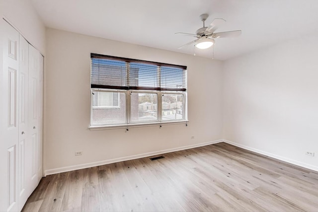 5350 N Damen Ave Unit F, Chicago, IL 60625 - unfurnished bedroom with a ceiling fan, visible vents, wood finished floors, baseboards, and a closet
