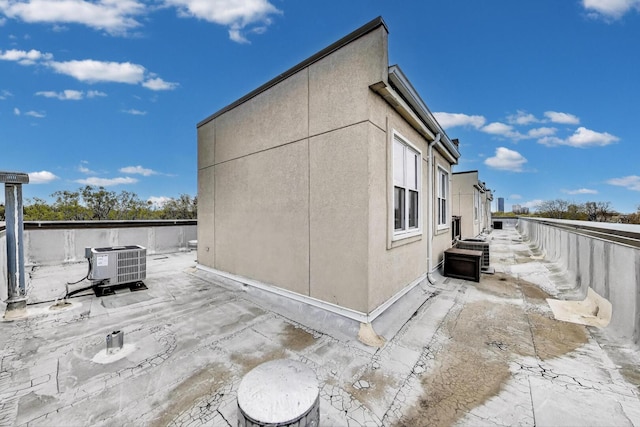 5350 N Damen Ave Unit F, Chicago, IL 60625 - view of property exterior with central AC, fence, and stucco siding