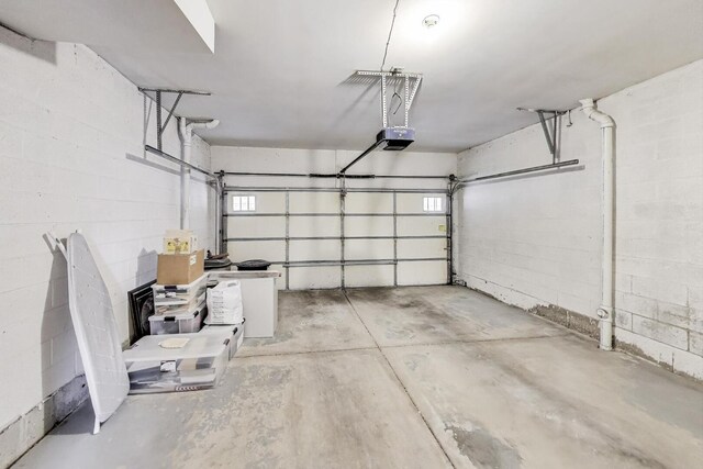 5350 N Damen Ave Unit F, Chicago, IL 60625 - garage featuring concrete block wall and a garage door opener
