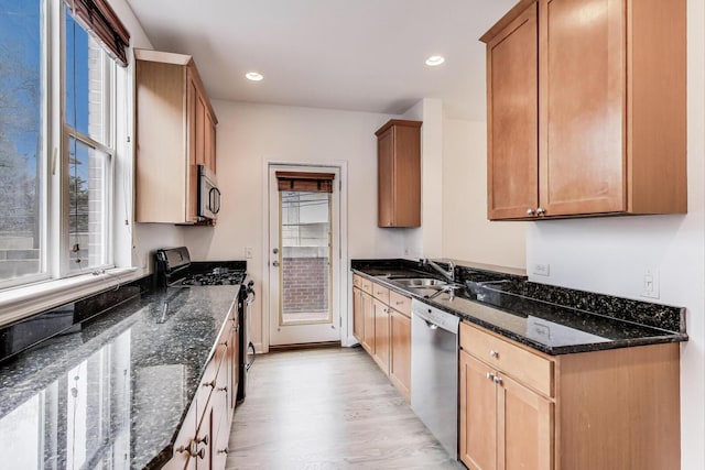 5350 N Damen Ave Unit F, Chicago, IL 60625 - kitchen with appliances with stainless steel finishes, a sink, dark stone countertops, light wood finished floors, and recessed lighting