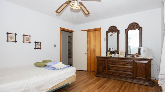 bedroom featuring ceiling fan, a closet, and wood finished floors