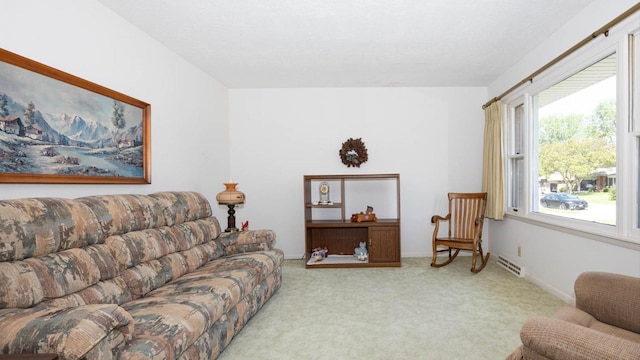 carpeted living area featuring baseboards and visible vents