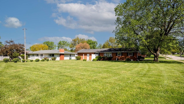 rear view of property with a yard