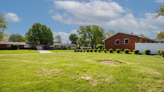 view of yard featuring fence and a garage