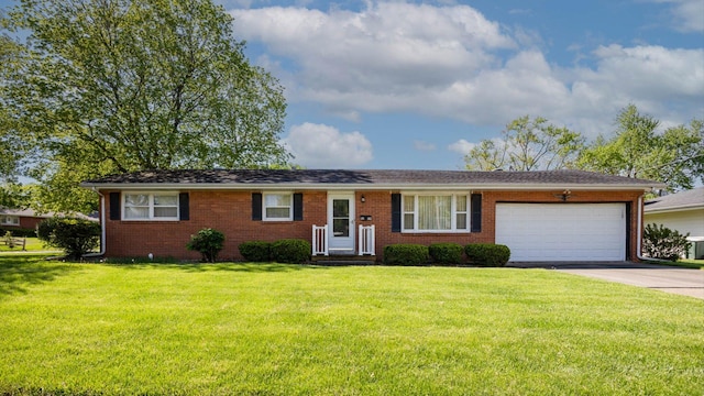 single story home featuring concrete driveway, an attached garage, a front lawn, and brick siding