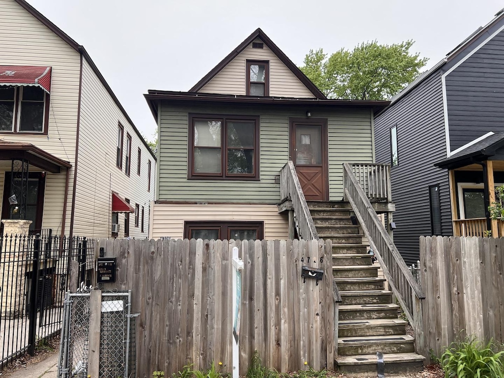 view of front of house featuring fence