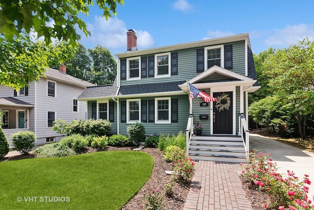 122 Logan Ave, Geneva, IL 60134 - view of front of property with a chimney, a front lawn, and roof with shingles