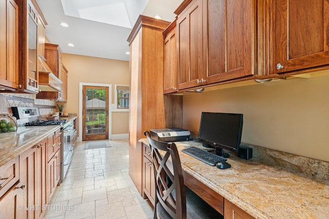 122 Logan Ave, Geneva, IL 60134 - kitchen featuring stainless steel gas range, stone tile floors, backsplash, brown cabinets, and recessed lighting