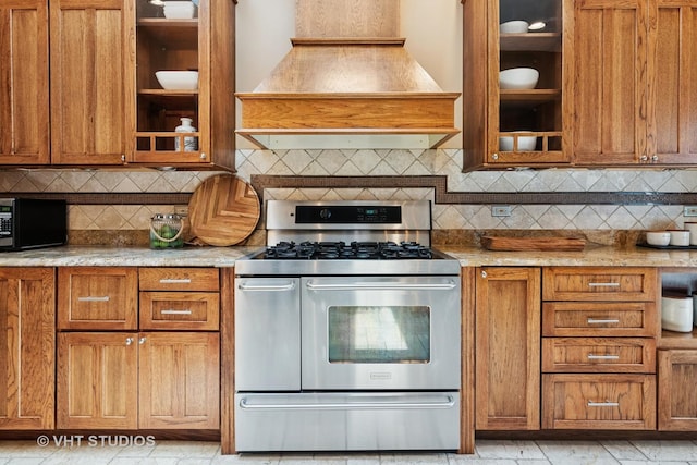 122 Logan Ave, Geneva, IL 60134 - kitchen featuring range with two ovens, premium range hood, brown cabinets, glass insert cabinets, and black microwave