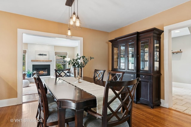 122 Logan Ave, Geneva, IL 60134 - dining space featuring a glass covered fireplace and wood finished floors